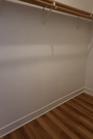 a view of a room with wooden floor