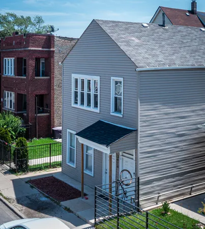 a view of a house with a backyard and a patio