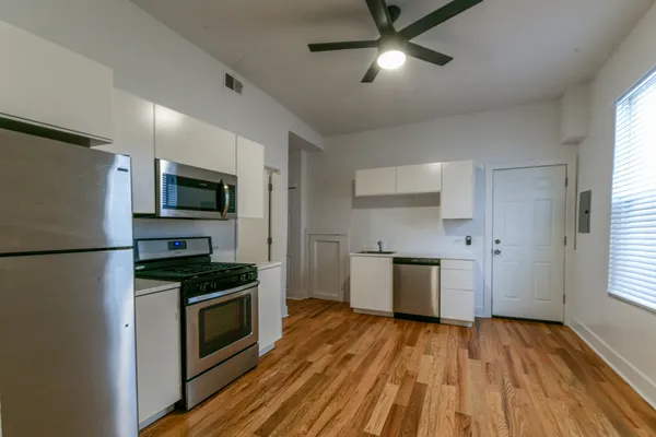 a kitchen with a refrigerator stove and microwave