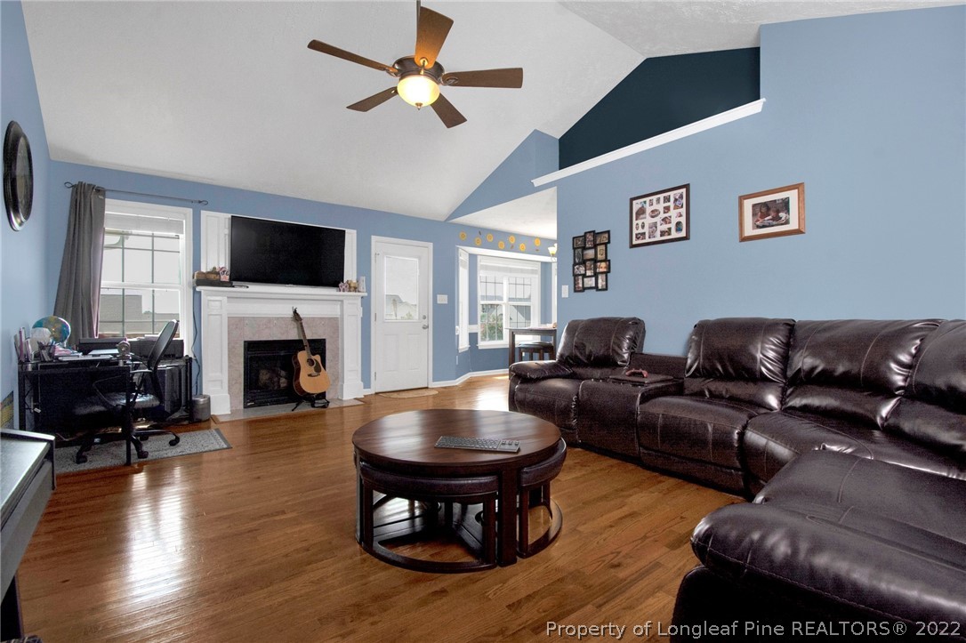 5415 Spreading Branch Road Hope Mills, NC 28348 - Photo 4 of 12 a living room with furniture a fireplace and a flat screen tv