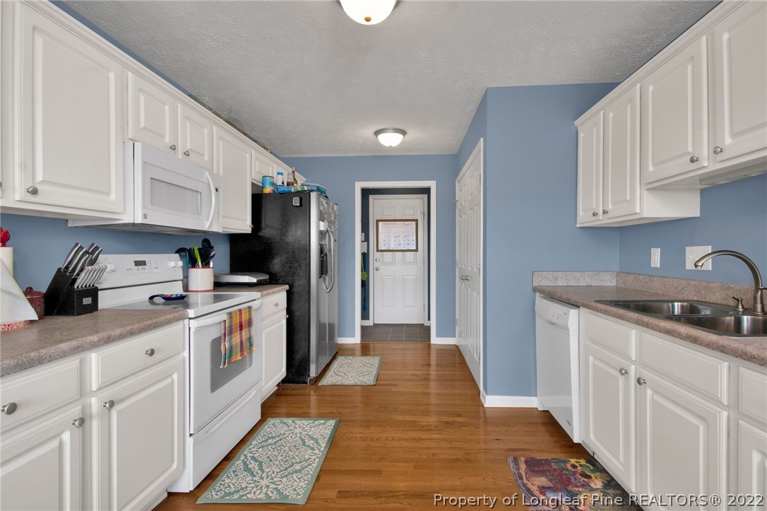 5415 Spreading Branch Road Hope Mills, NC 28348 - Photo 7 of 12 a kitchen with granite countertop a sink stove and cabinets
