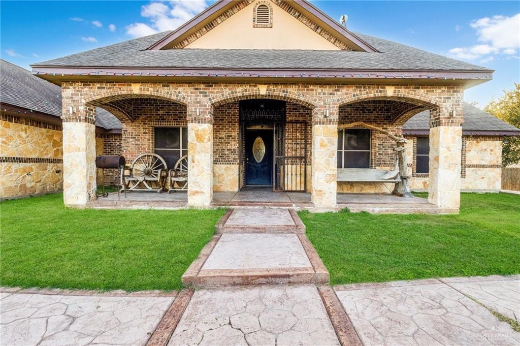 22811 Skinner Road Edcouch, TX 78538 - Photo 10 of 38 Brick exterior with stone accents and a covered front porch featuring arched openings