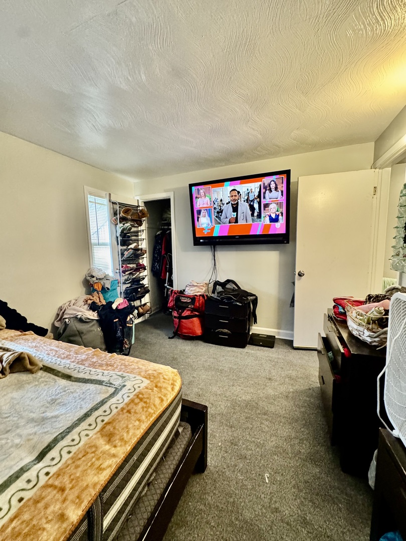 11345 South Ada Street Chicago, IL 60643 - Photo 11 of 15 a bed room with furniture and a flat screen tv