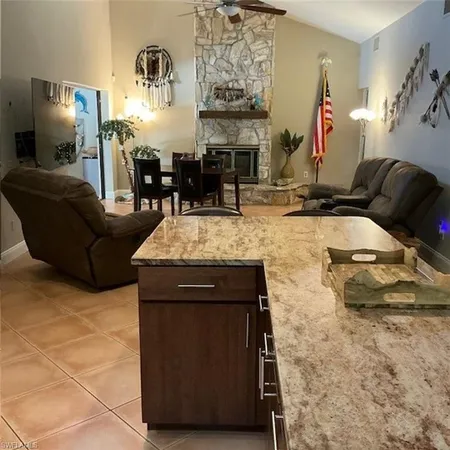 a living room with fireplace furniture and a fireplace