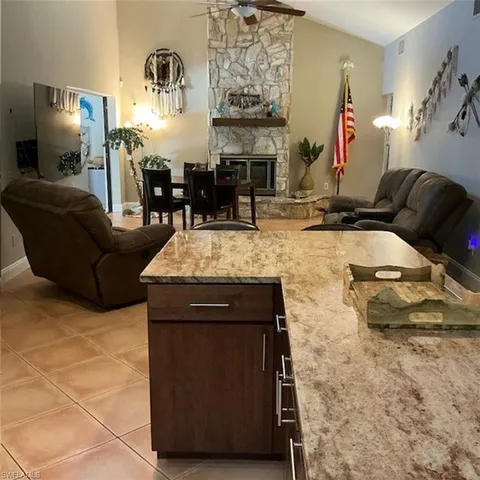 a living room with fireplace furniture and a fireplace