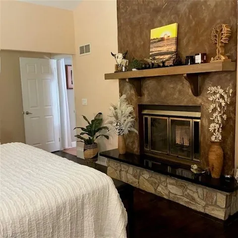 a bedroom with a bed and a fireplace