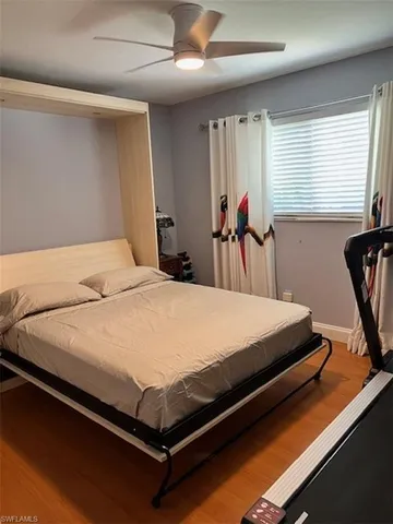 a bed sitting in a bedroom next to a window