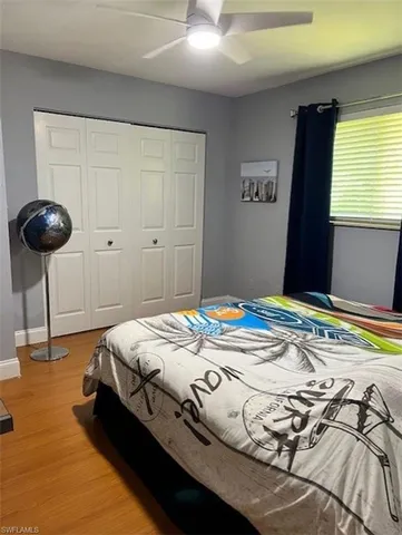 a bedroom with bed and a chandelier