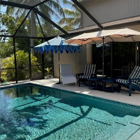 a view of patio with a table and chairs under an umbrella