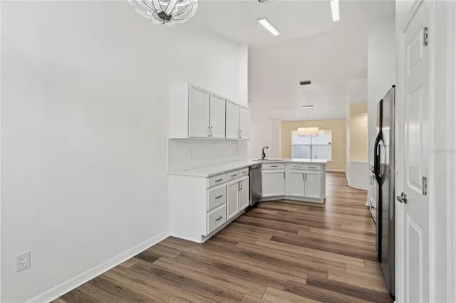 a kitchen with white cabinets and white appliances