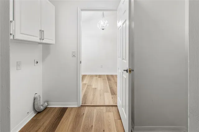 a view of a room with wooden floor and a sink