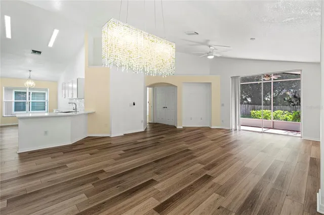 an empty room with wooden floor and door