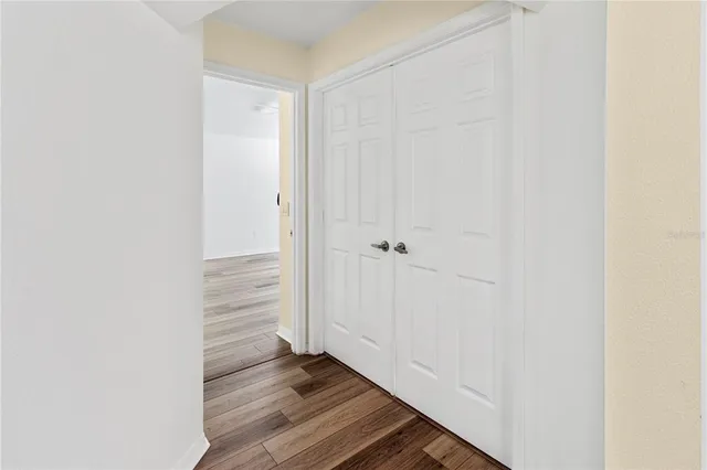 a view of a room with wooden floor