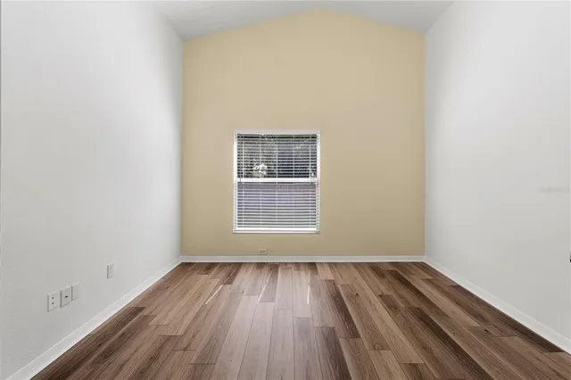 a view of room with window and hardwood floor