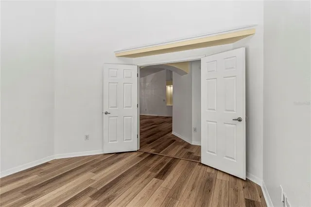 a view of a room with wooden floor and staircase