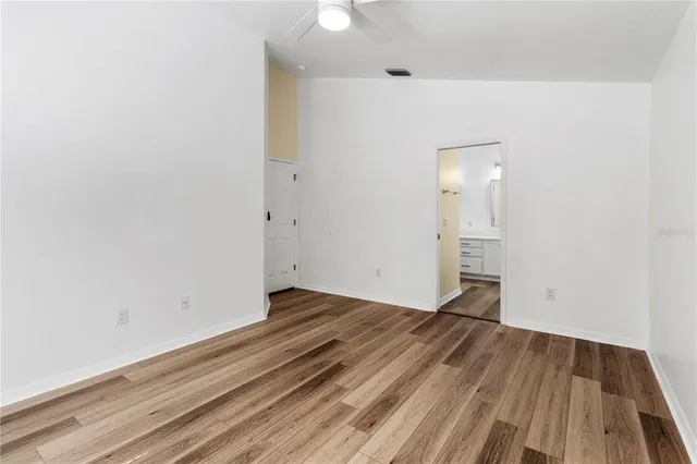 a view of a room with wooden floor and a sink