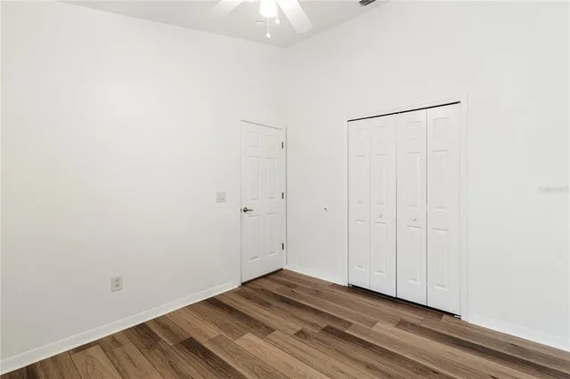a view of a room with wooden floor