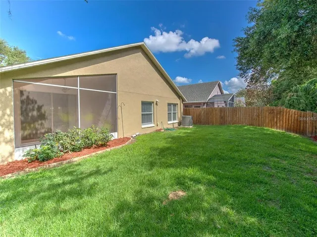 a view of an house with backyard space and garden