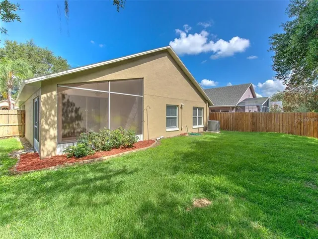 a view of a house with backyard and garden
