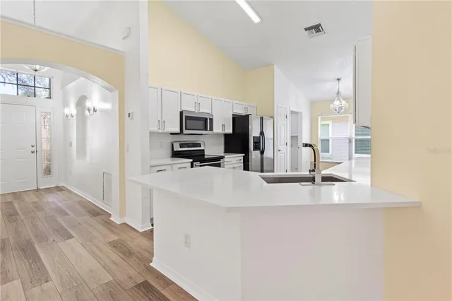 a view of kitchen and refrigerator