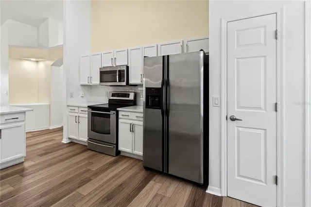 a kitchen with stainless steel appliances a refrigerator stove and microwave