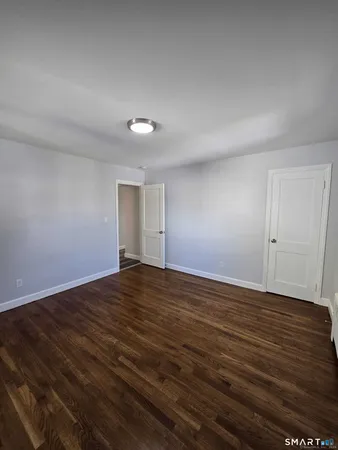 a view of an empty room and wooden floor