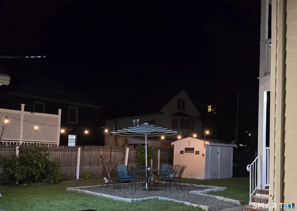 a view of a patio with a table and chairs