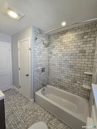 a bathroom with a bathtub and a shower
