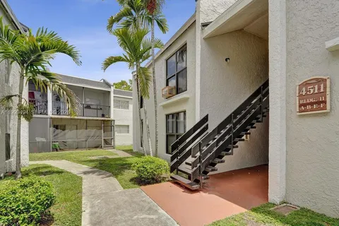 a view of a house with a yard and plants