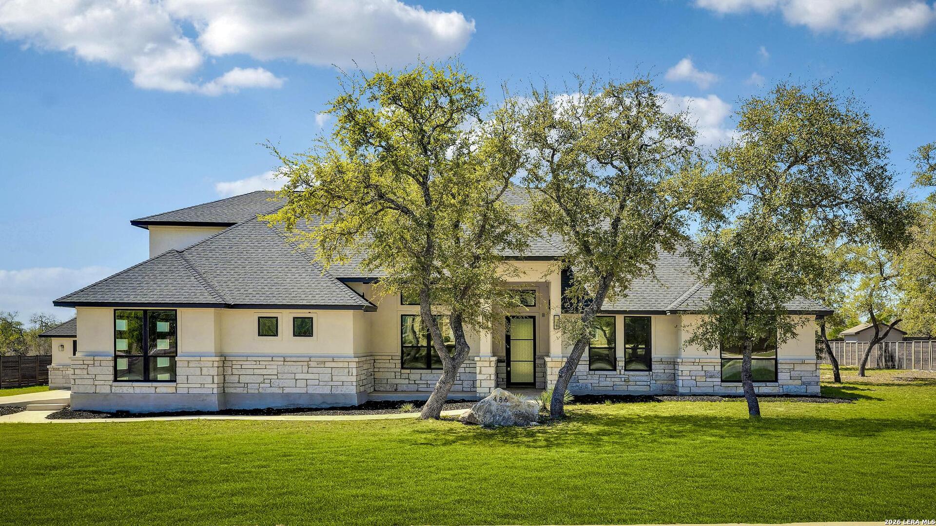 a front view of house with yard and green space