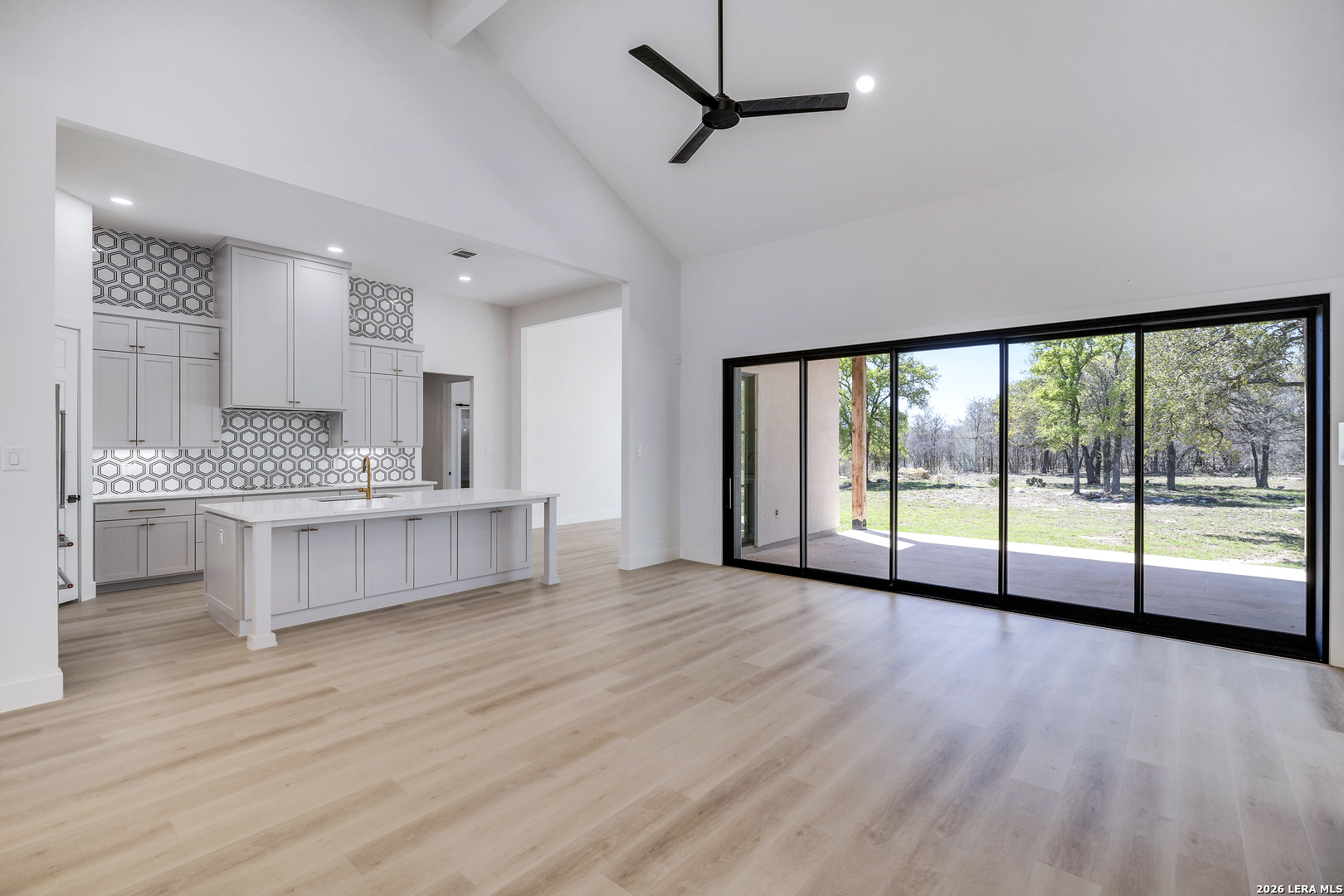486 James Castroville, TX 78009 - Photo 11 of 29 a large white kitchen with a large window and stainless steel appliances