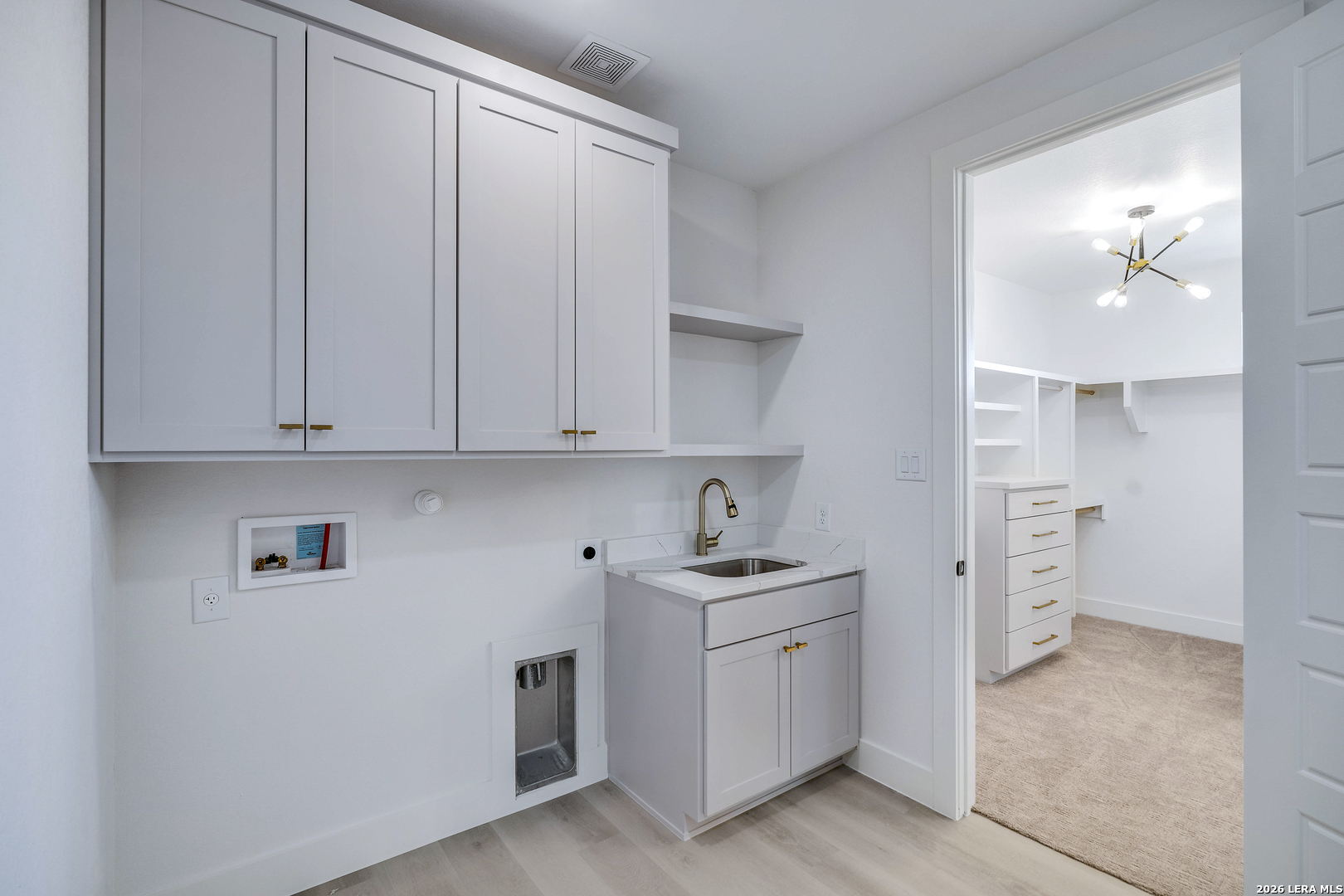 486 James Castroville, TX 78009 - Photo 18 of 29 a kitchen with cabinets and white appliances