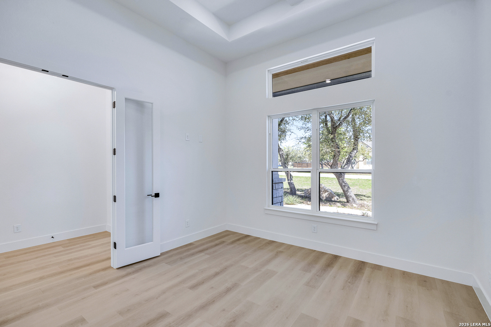 486 James Castroville, TX 78009 - Photo 20 of 29 an empty room with wooden floor and windows