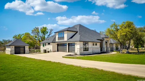 a front view of house with yard and green space
