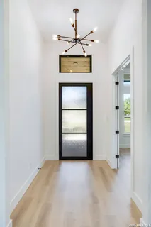 a view of an empty room with a fireplace and window