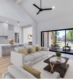 a large white kitchen with a large window and stainless steel appliances