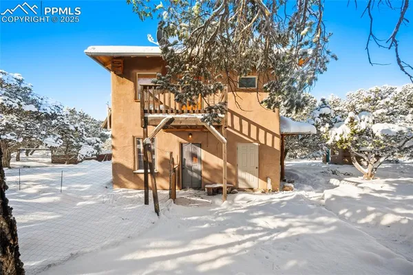 a view of a house with a snow in the yard