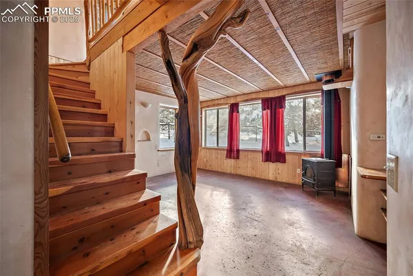 a view of an entryway with wooden floor and windows