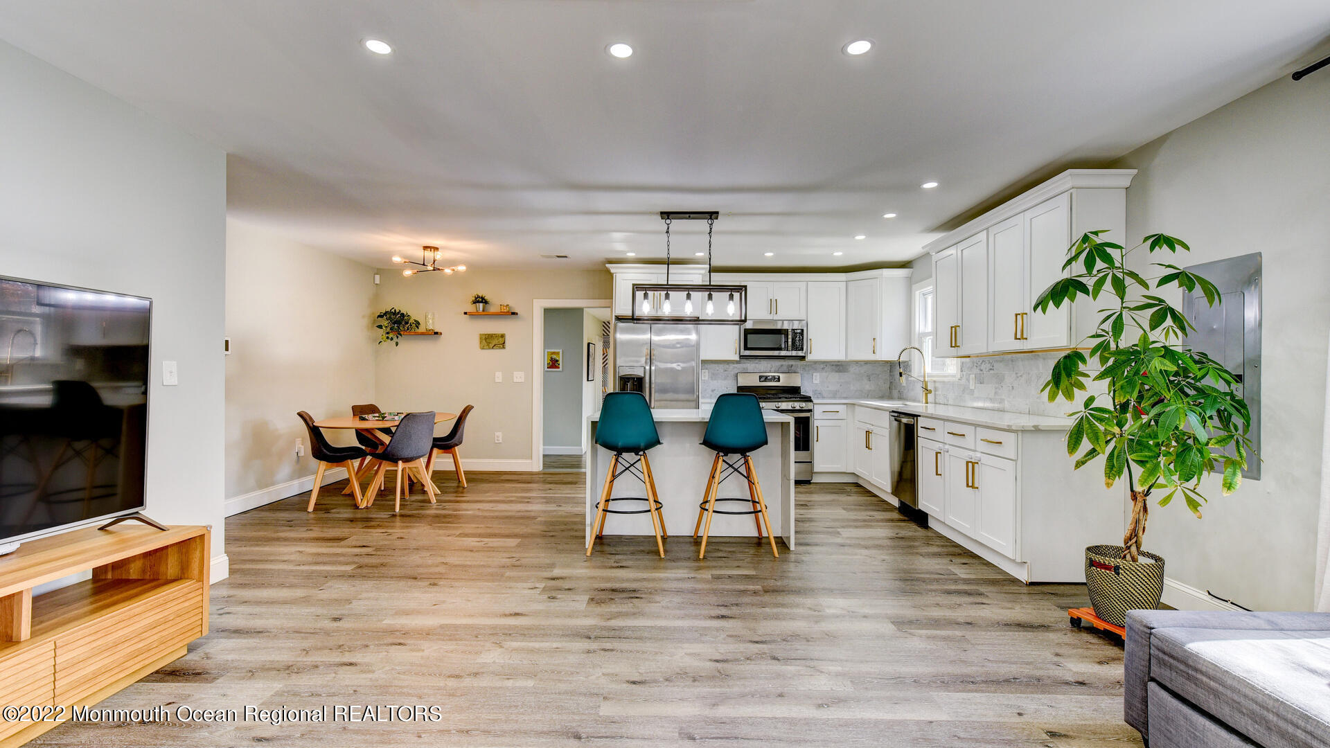 204 Paint Island Spring Road Millstone Township, NJ 08510 - Photo 15 of 30 a living room with kitchen island furniture and a potted plant