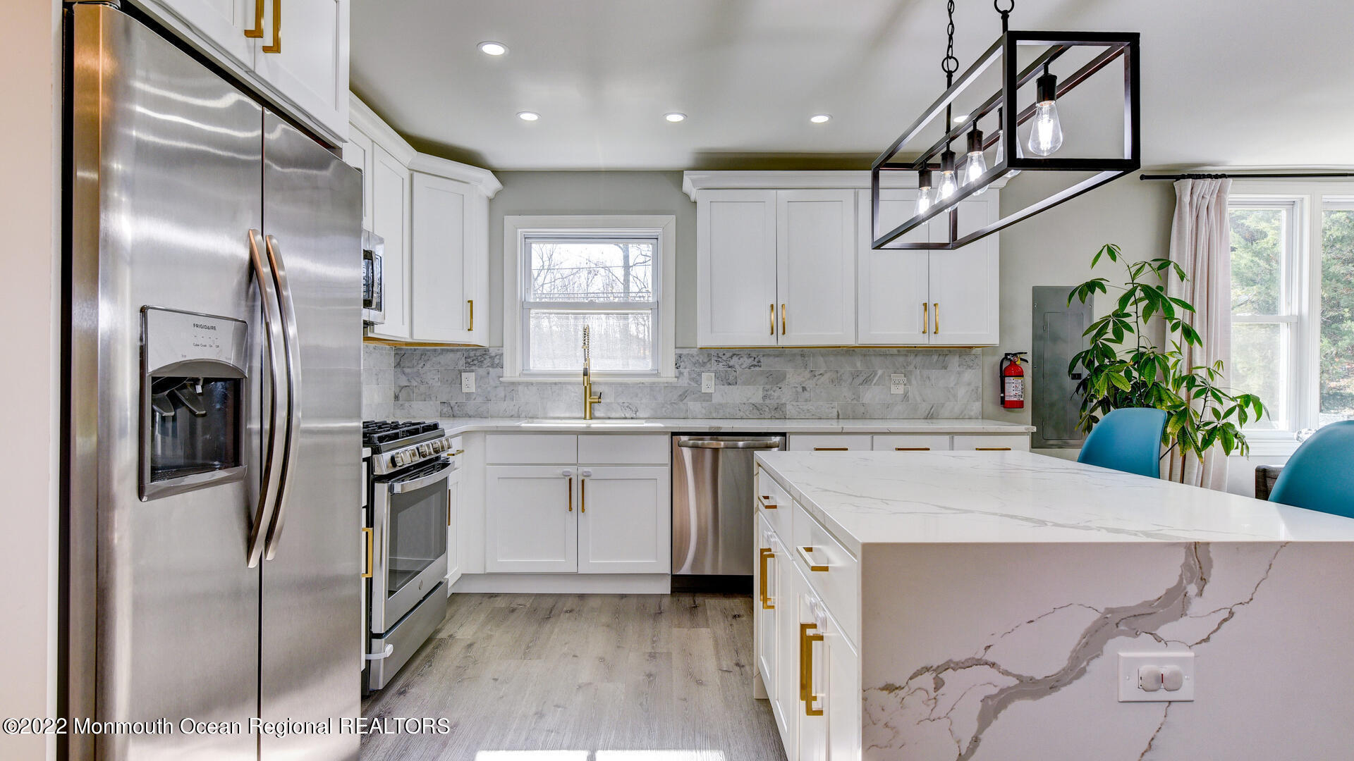 204 Paint Island Spring Road Millstone Township, NJ 08510 - Photo 7 of 30 a kitchen with stainless steel appliances kitchen island granite countertop a refrigerator a sink a stove and white cabinets