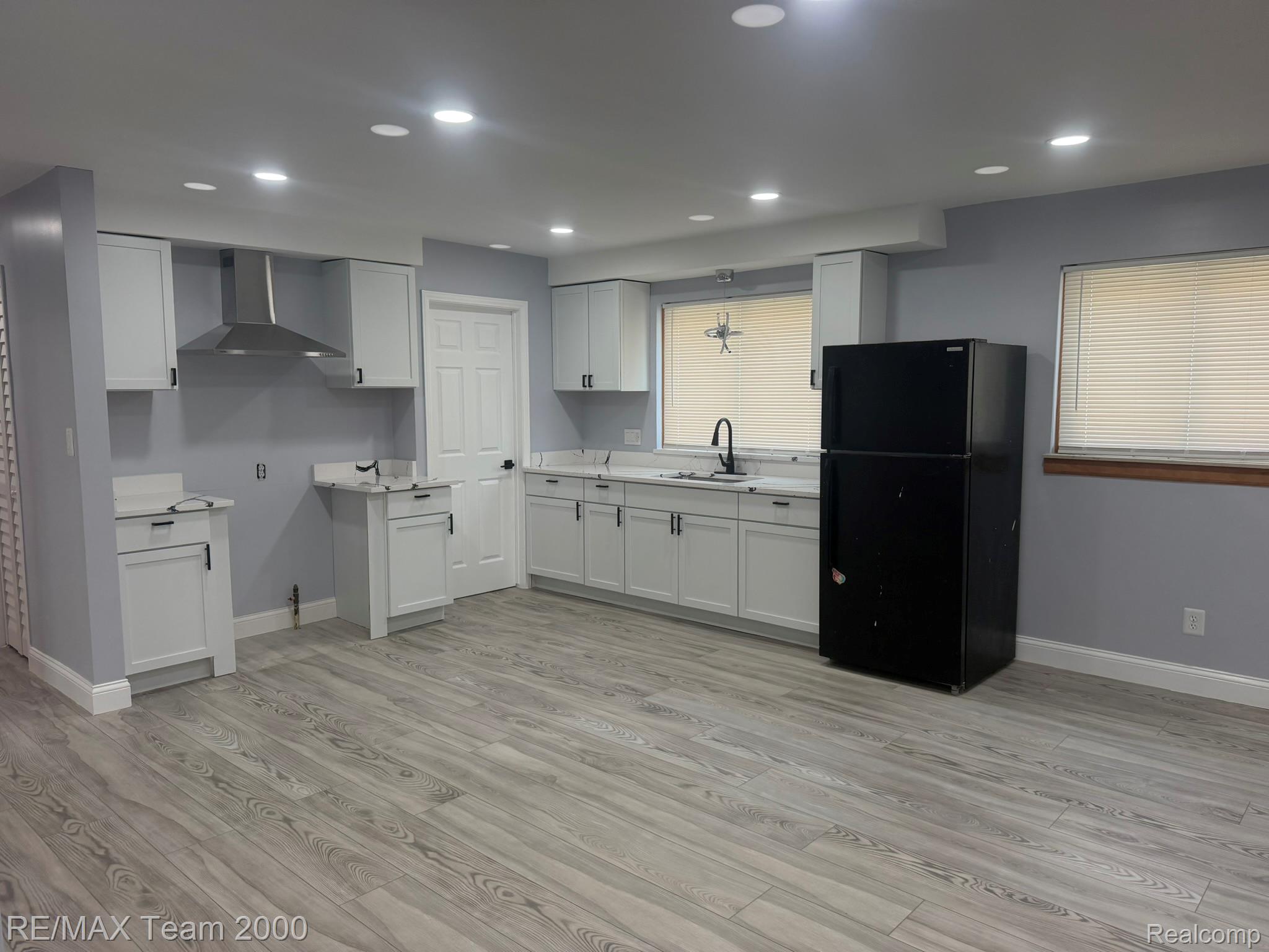9023 Evergreen Road Detroit, MI 48228 - Photo 8 of 21 Kitchen featuring white cabinetry, light countertops, wood-finish flooring, and recessed lighting