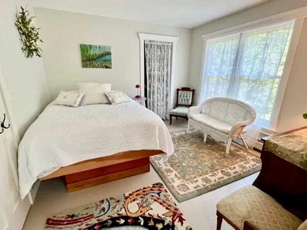 a bedroom with a bed window and couch