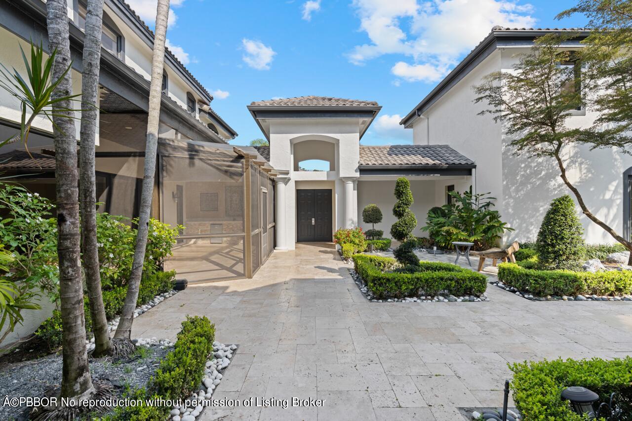 22771 El Dorado Drive Boca Raton, FL 33433 - Photo 11 of 24 a front view of a house with garden