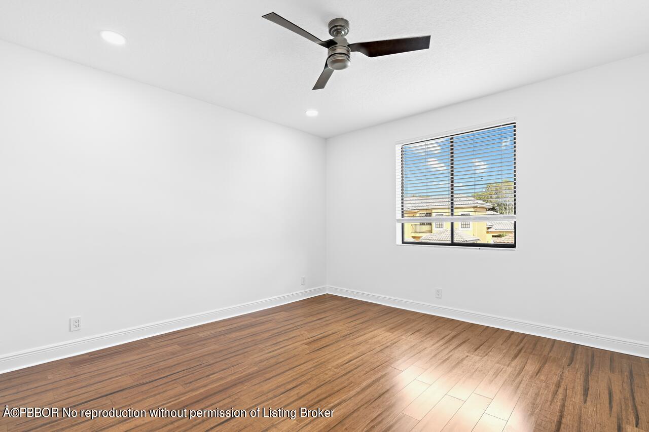 22771 El Dorado Drive Boca Raton, FL 33433 - Photo 14 of 24 an empty room with wooden floor and windows