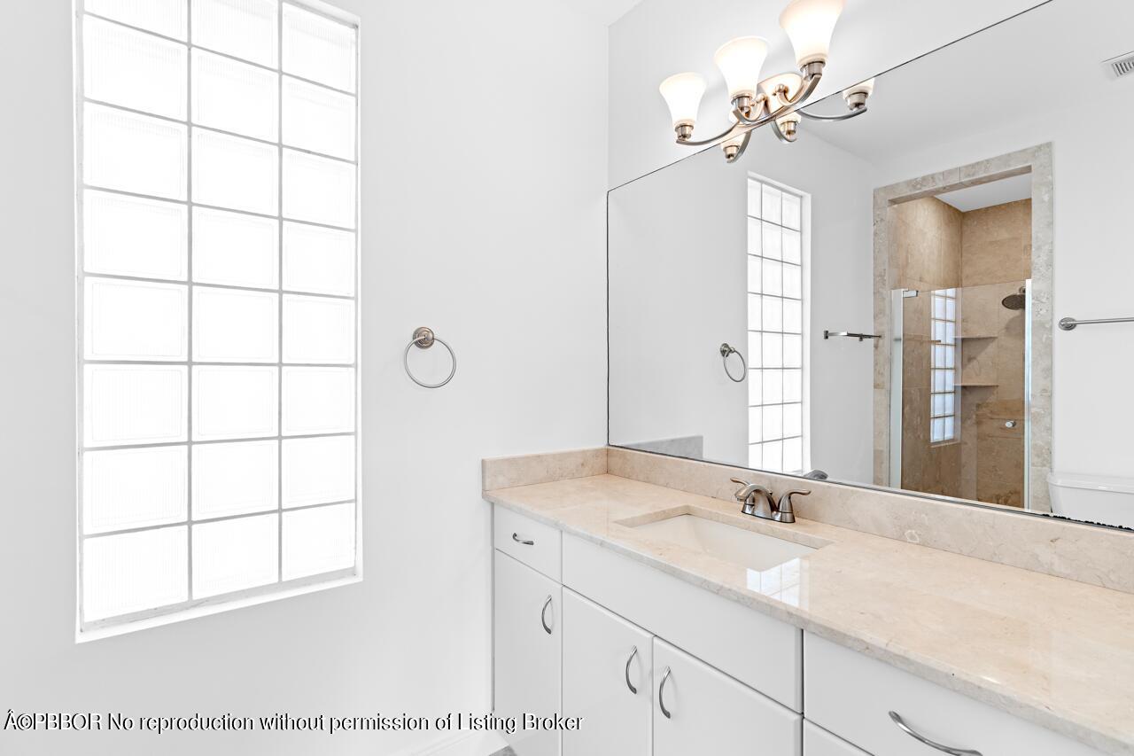 22771 El Dorado Drive Boca Raton, FL 33433 - Photo 15 of 24 a bathroom with a granite countertop sink a shower and a mirror
