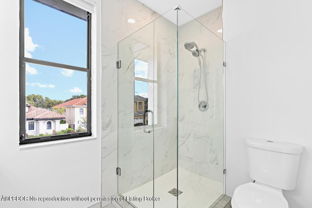 22771 El Dorado Drive Boca Raton, FL 33433 - Photo 17 of 24 a bathroom with a shower and toilet