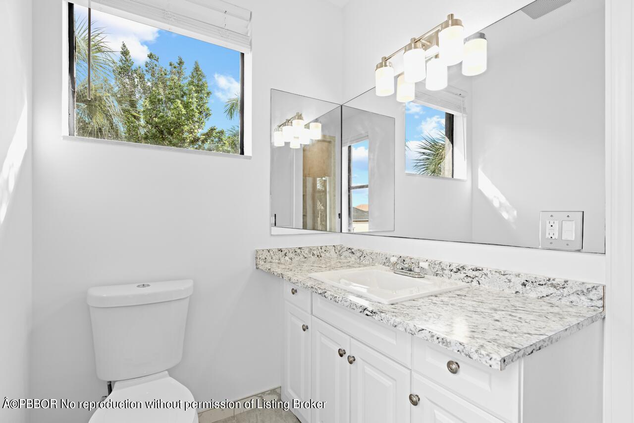 22771 El Dorado Drive Boca Raton, FL 33433 - Photo 20 of 24 a bathroom with a sink a toilet and a mirror