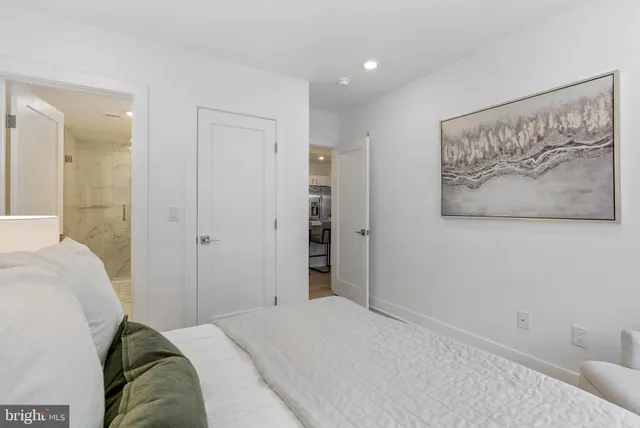 a bedroom with a bed and a painting on the wall