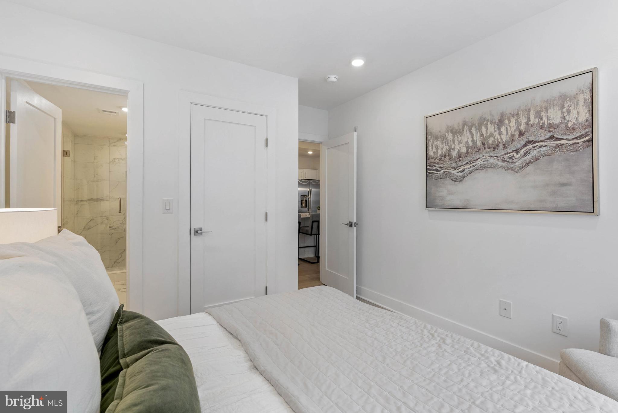 825 Bainbridge Street, Unit 101 Philadelphia, PA 19147 - Photo 11 of 27 a bedroom with a bed and a painting on the wall