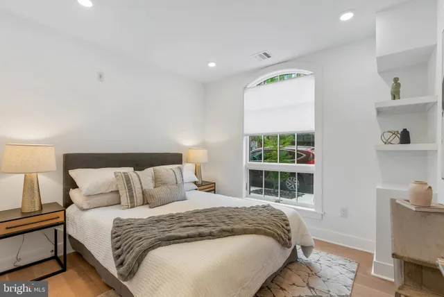 a bedroom with a bed and a window